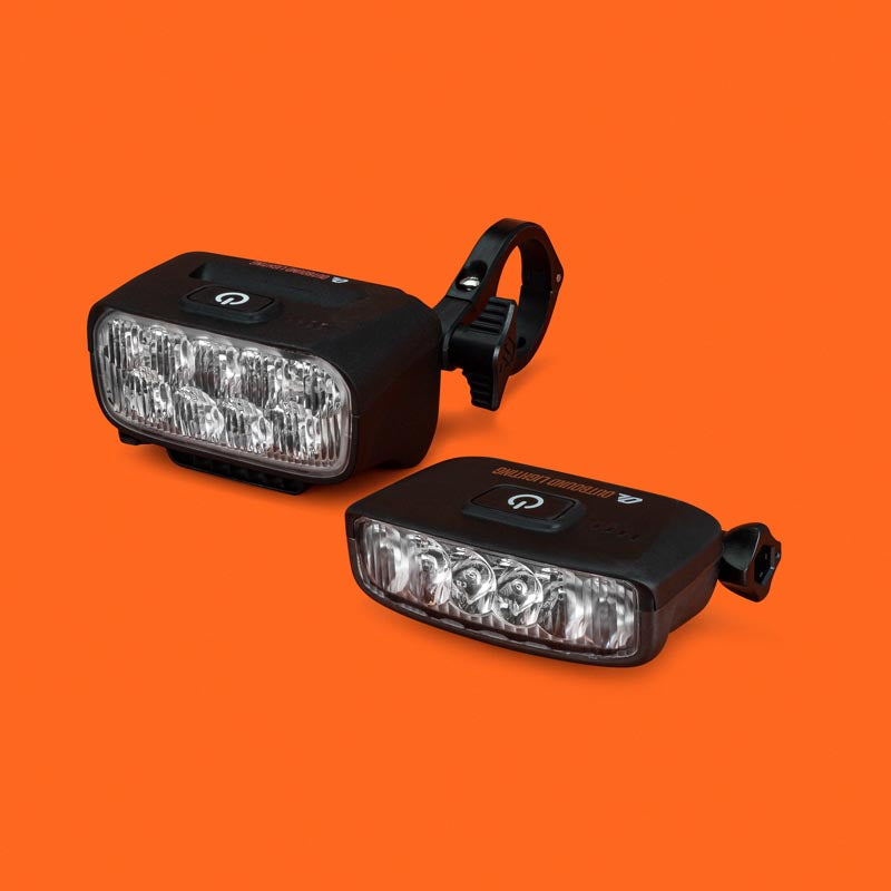 Trail Evo handlebar light and Hangover helmet light together, front three-quarter view