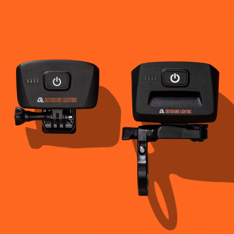Hangover helmet light and Trail Evo handlebar light side by side, rear view showing the power buttons and mounts